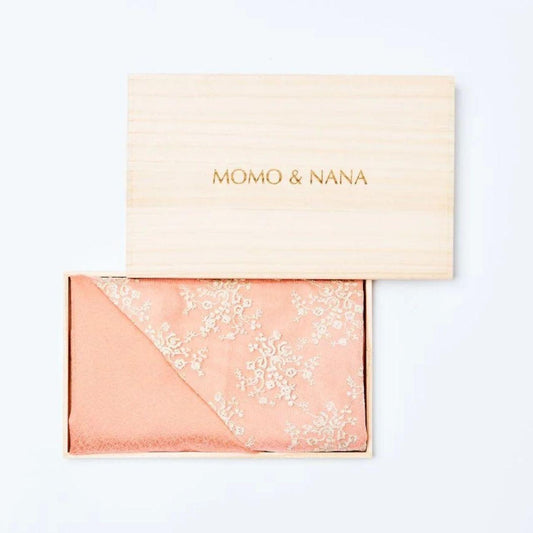 Exquisite MOMO & NANA luxury silk hijab presented in a handcrafted traditional Japanese paulownia wood box, signifying premium quality and artisanal heritage