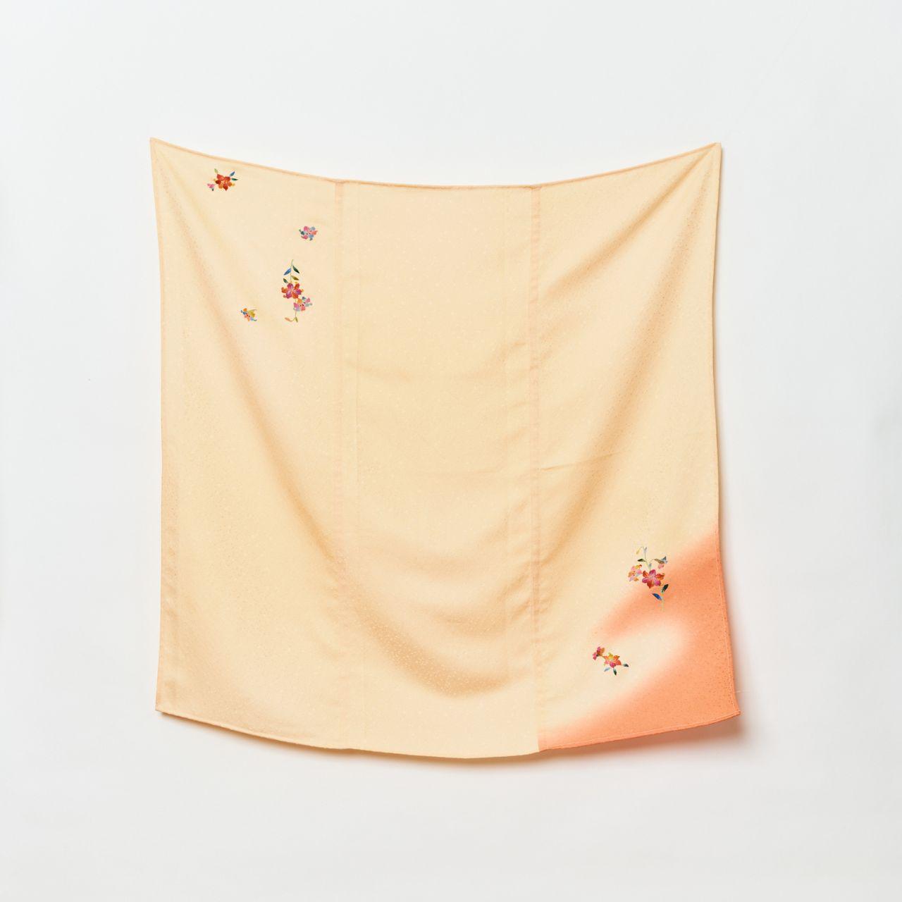 Full view of a square Japanese scarf in soft cream, showing a crimson gradient corner and scattered floral embroidery on high-quality chirimen silk.