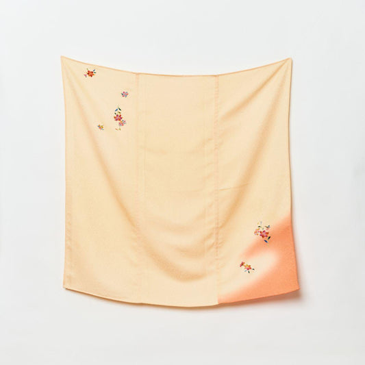 Full view of a square Japanese scarf in soft cream, showing a crimson gradient corner and scattered floral embroidery on high-quality chirimen silk.