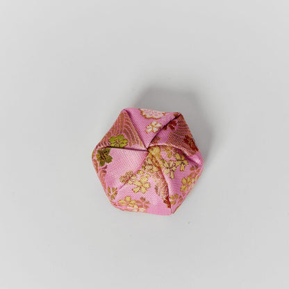 Top view of a handcrafted fabric accessory case showing the elegant folded design of pink Japanese kimono silk.