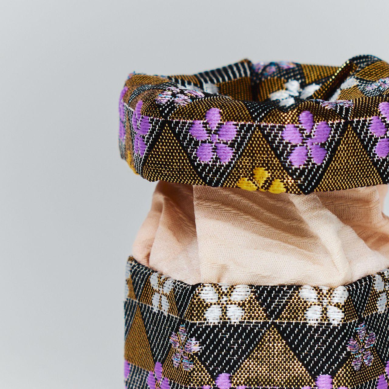 Close-up of the intricate texture of Japanese brocade silk and the soft interior lining of a handmade trinket box.