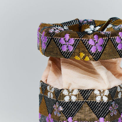 Close-up of the intricate texture of Japanese brocade silk and the soft interior lining of a handmade trinket box.