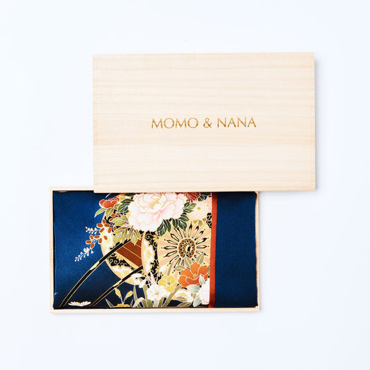 A luxury upcycled kimono silk hijab named "PATH THAT BIND," elegantly presented in a traditional Japanese paulownia (kiri) wood box featuring the MOMO & NANA brand logo.