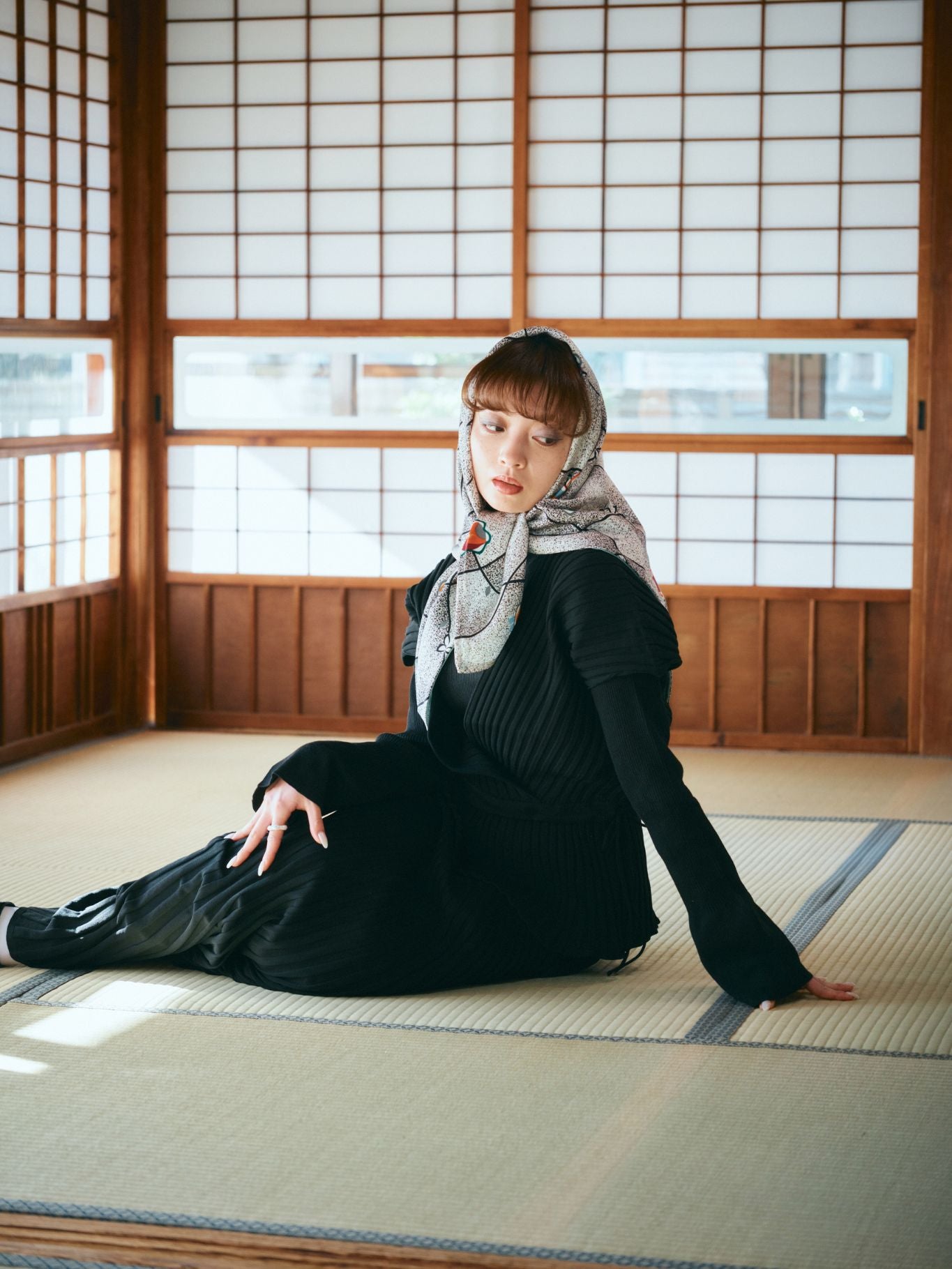 A woman styled in a sophisticated silk hijab repurposed from traditional Komon kimono, showcasing delicate repetitive patterns for a refined daily look.